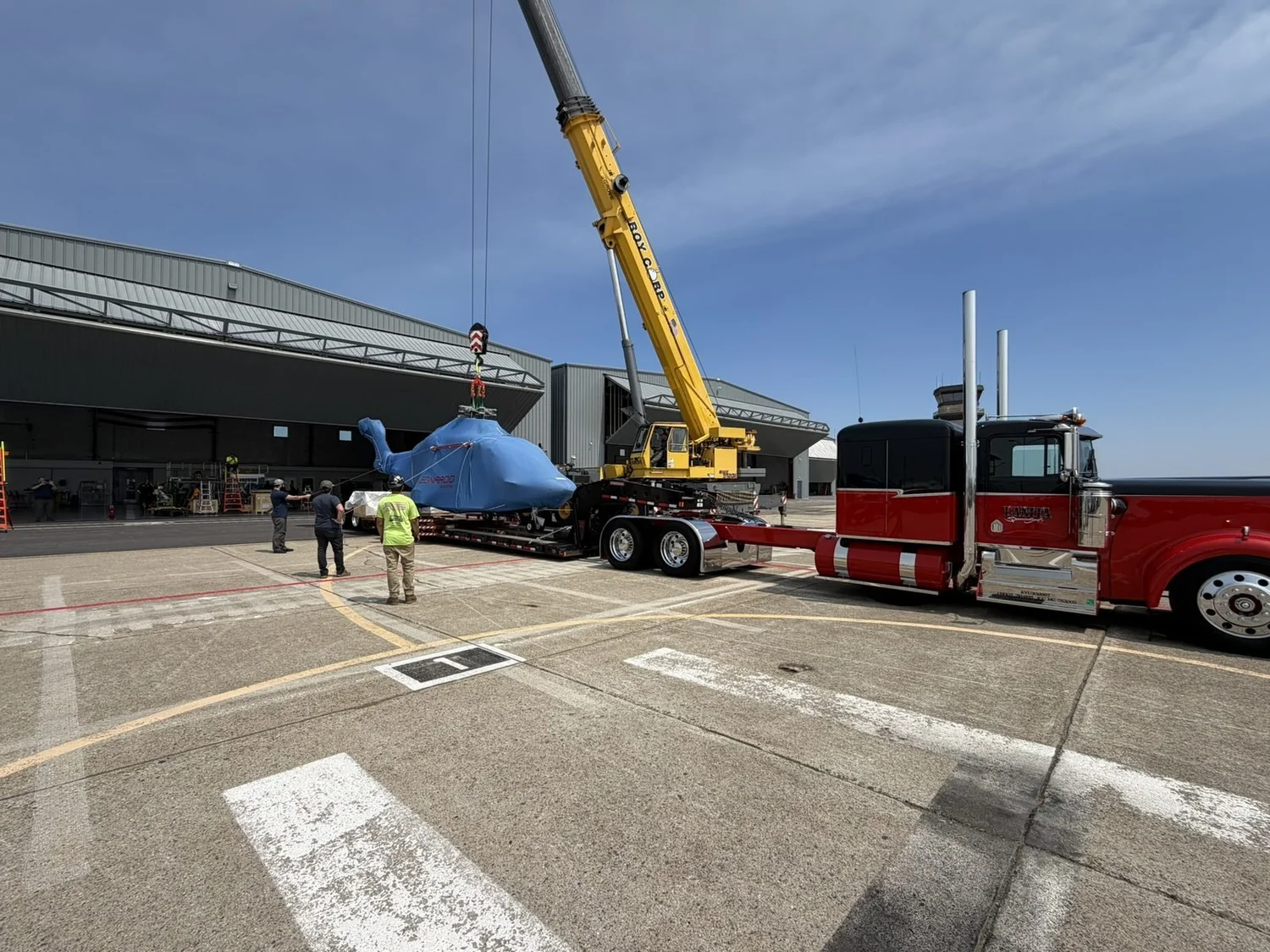 Roy Corp crane lifting a helicopter at Quonset Point, RI