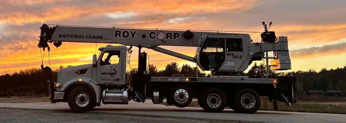 Roy Corp boom truck crane at sunset
