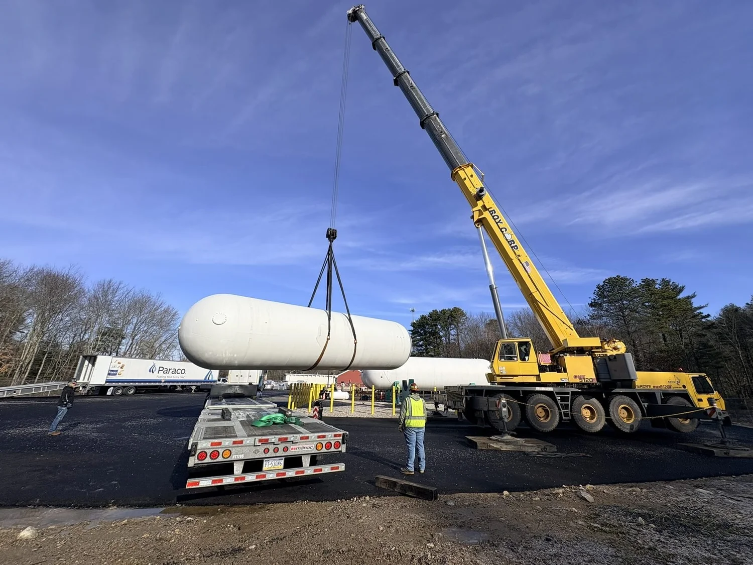Crane offloading a large tank from a trailer in Connecticut