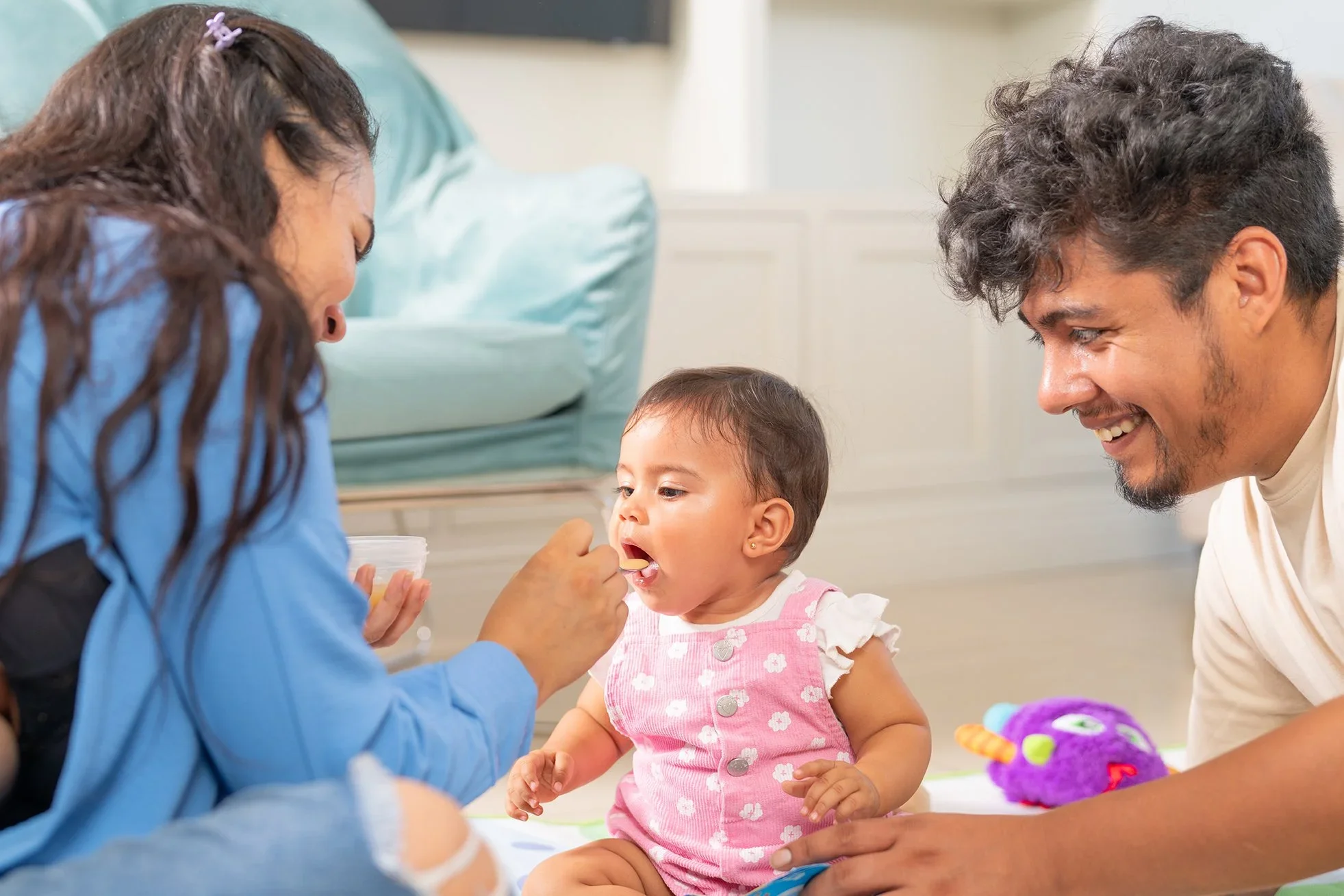 Mother feeding a baby during early allergen introduction