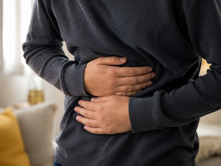 Person holding their stomach to illustrate gastrointestinal allergy symptoms