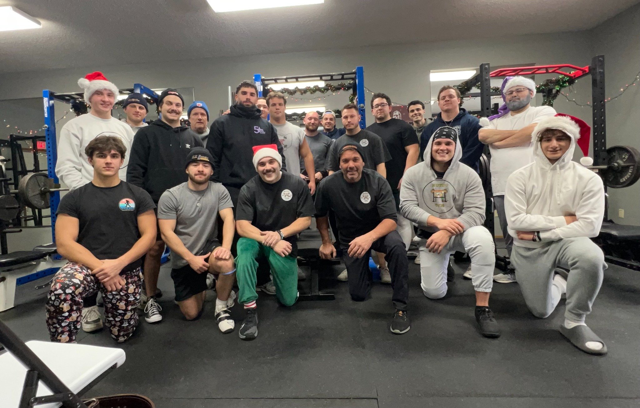 The Mutz’s Gym crew gathered inside the gym beneath festive decorations