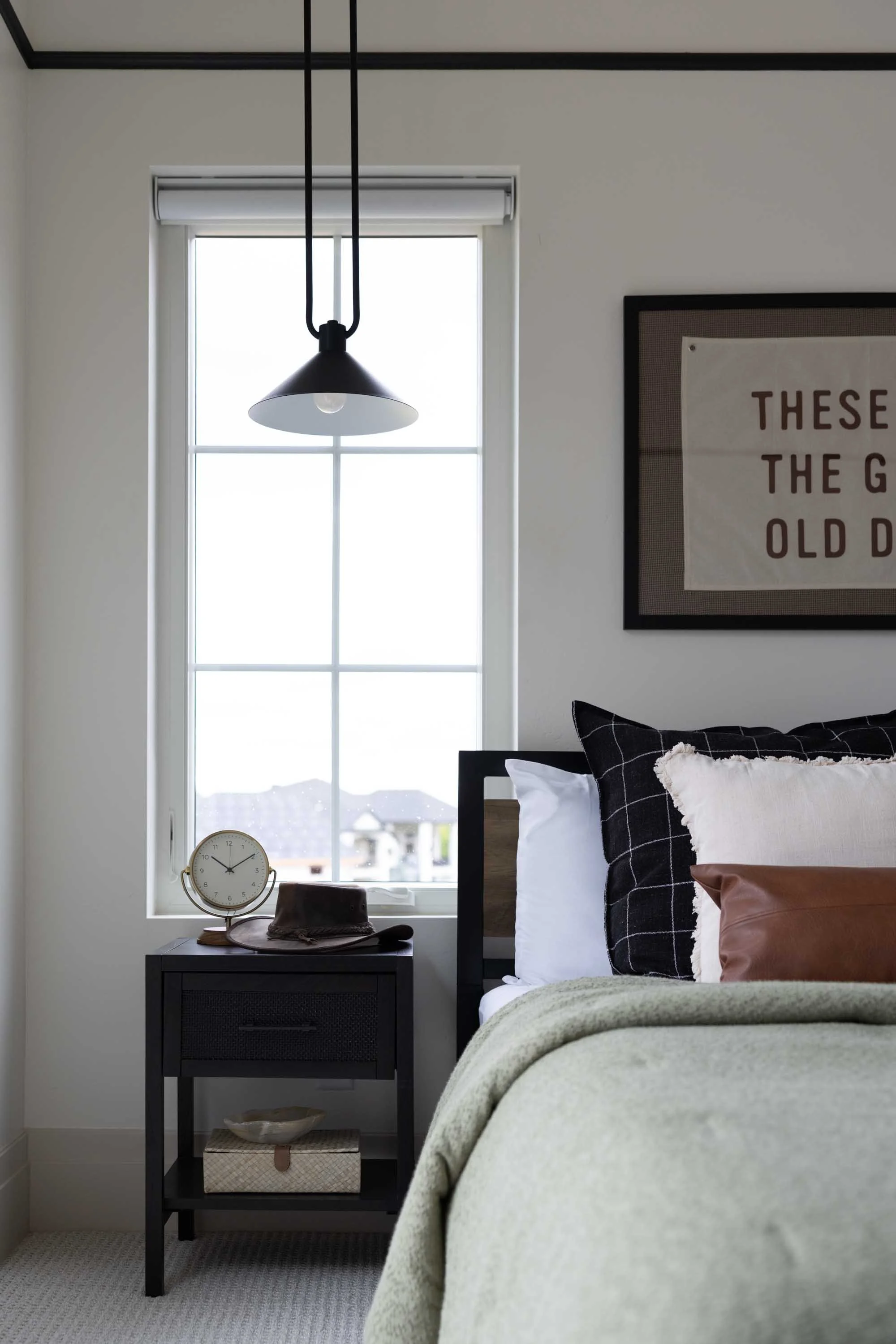 Bedroom with a black pendant