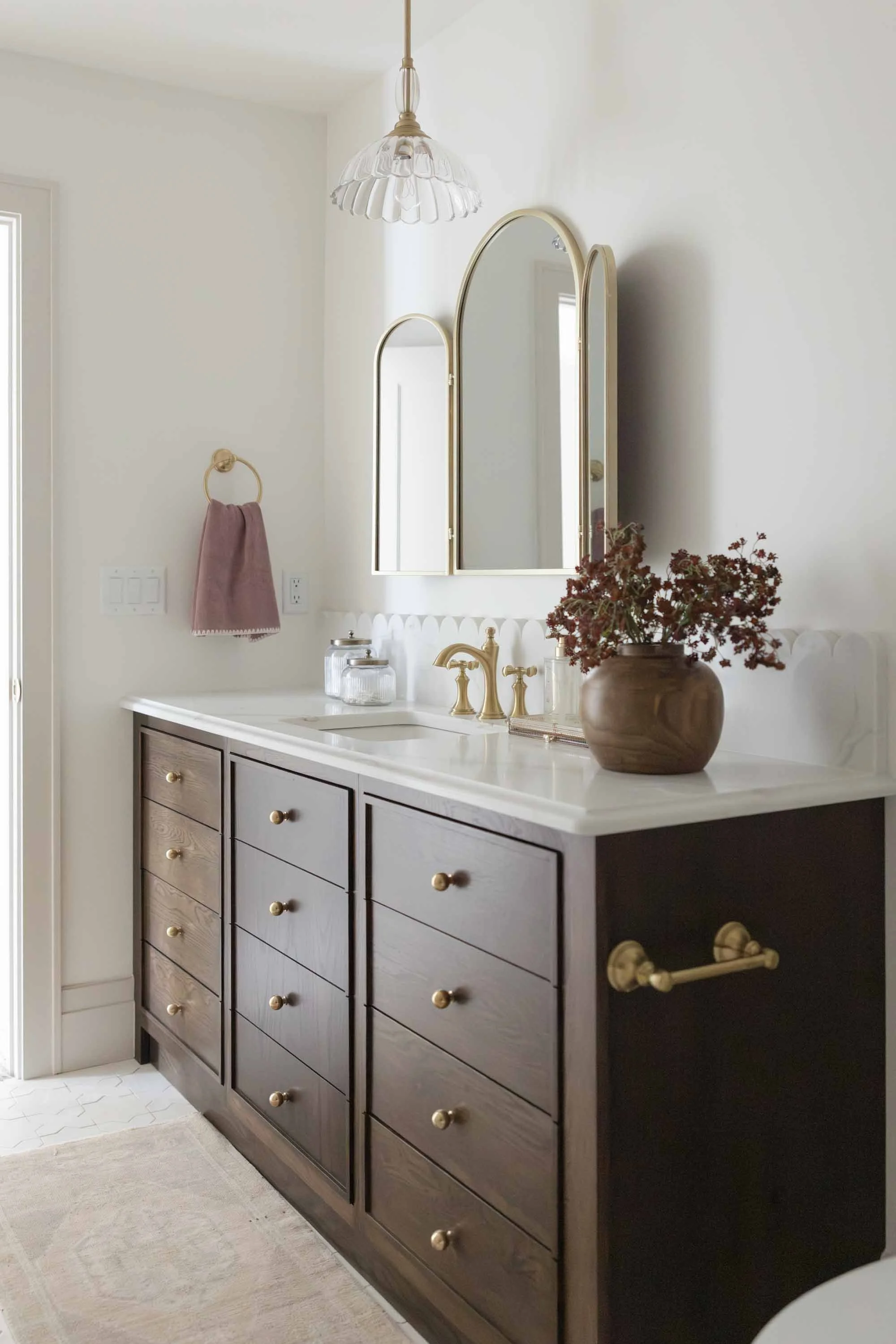 Bathroom vanity with an arched mirror