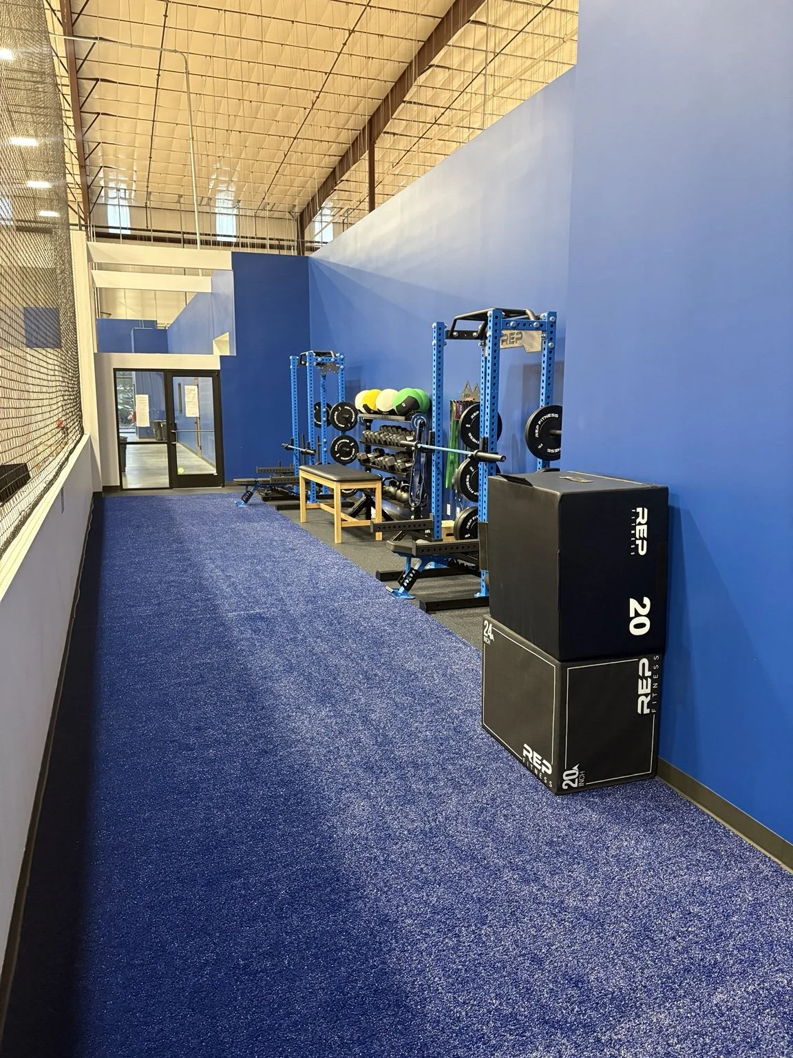 MaxxFIT Katy: A training lane with racks, medicine balls, and plyometric boxes.