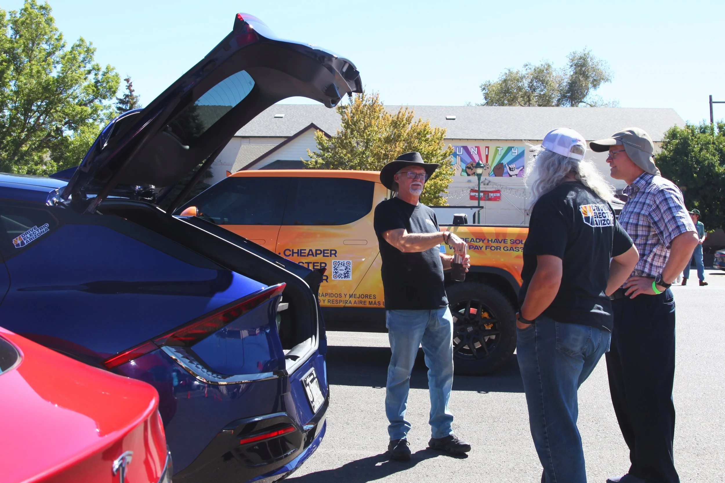 EV enthusiasts alongside the vehicle lineup