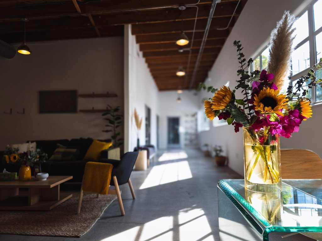 A bright hallway and fresh flowers inside âme vitality in Santa Monica.