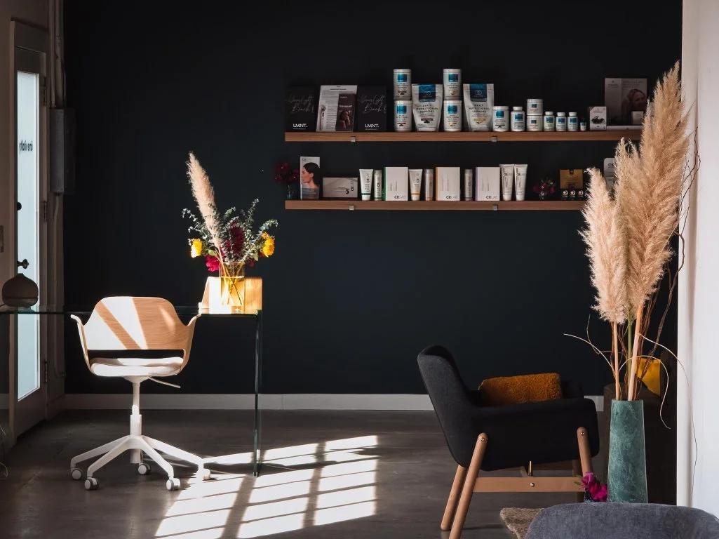 The âme vitality front desk, with product shelves and a glass reception desk.