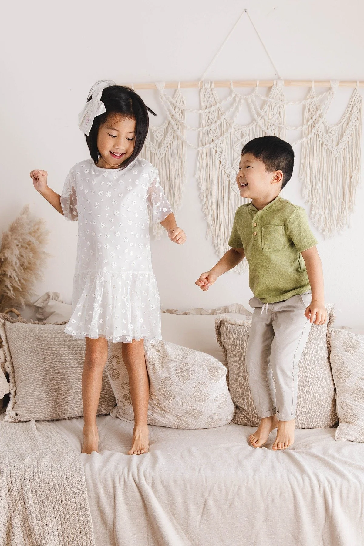 Lifestyle maternity photography in Allen, Texas: sibling portrait in a soft neutral studio, photographed by Manal Ansari