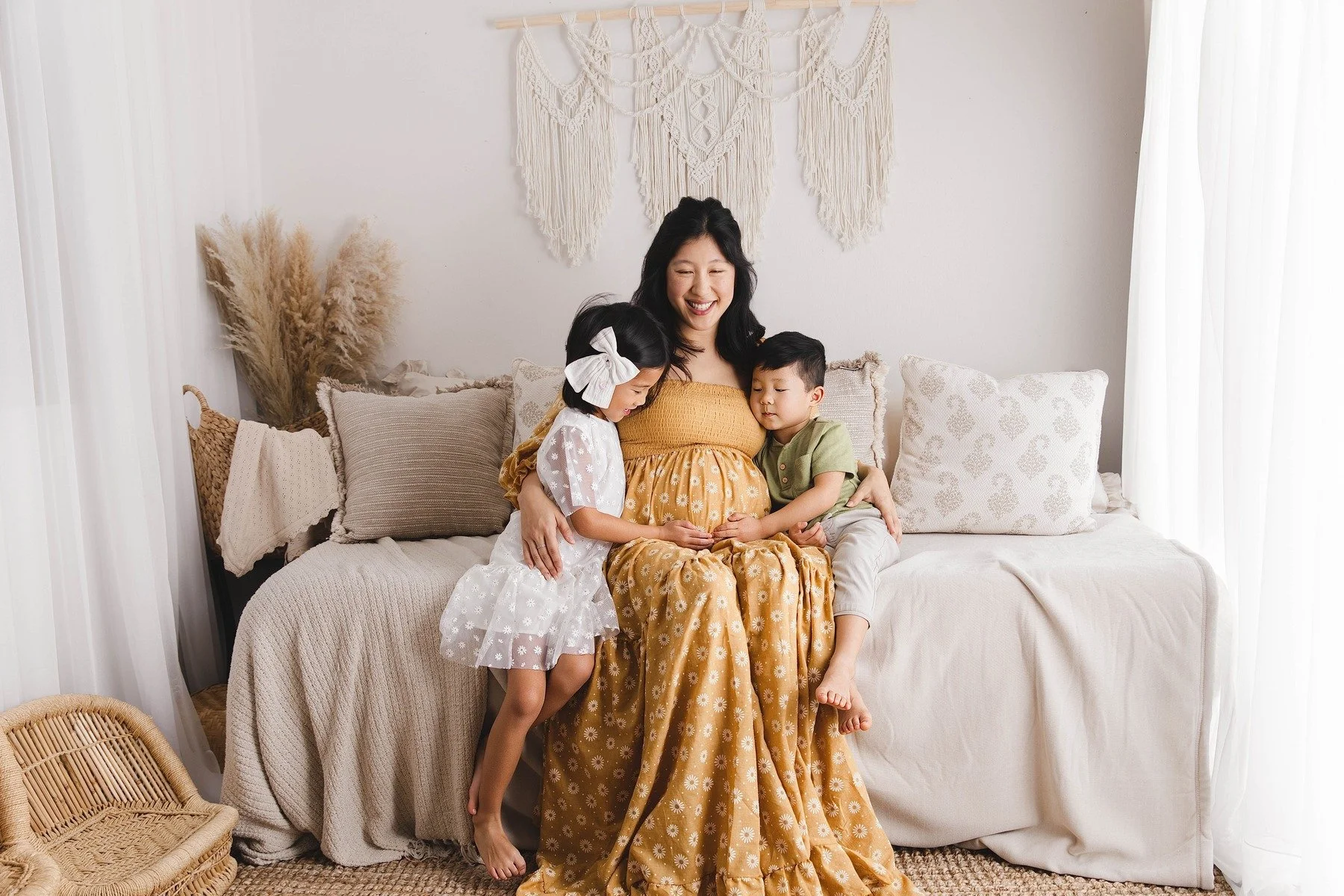 Lifestyle maternity photography in Allen, Texas: mother and children in a soft neutral studio, photographed by Manal Ansari