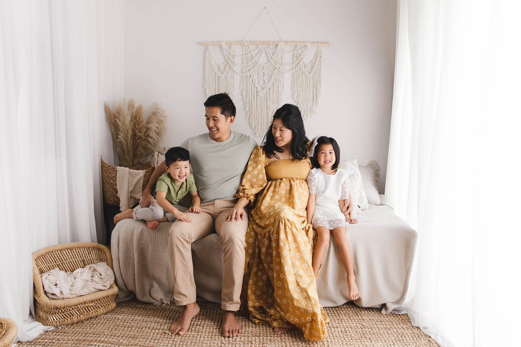 Lifestyle maternity photography in Allen, Texas: family portrait in a soft neutral studio, photographed by Manal Ansari