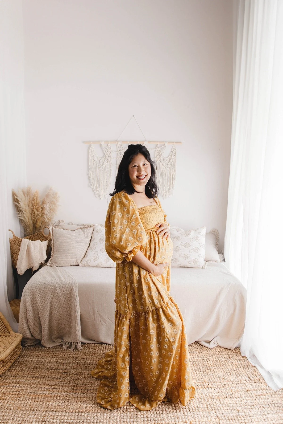 Lifestyle maternity photography in Allen, Texas: solo maternity portrait in a soft neutral studio, photographed by Manal Ansari