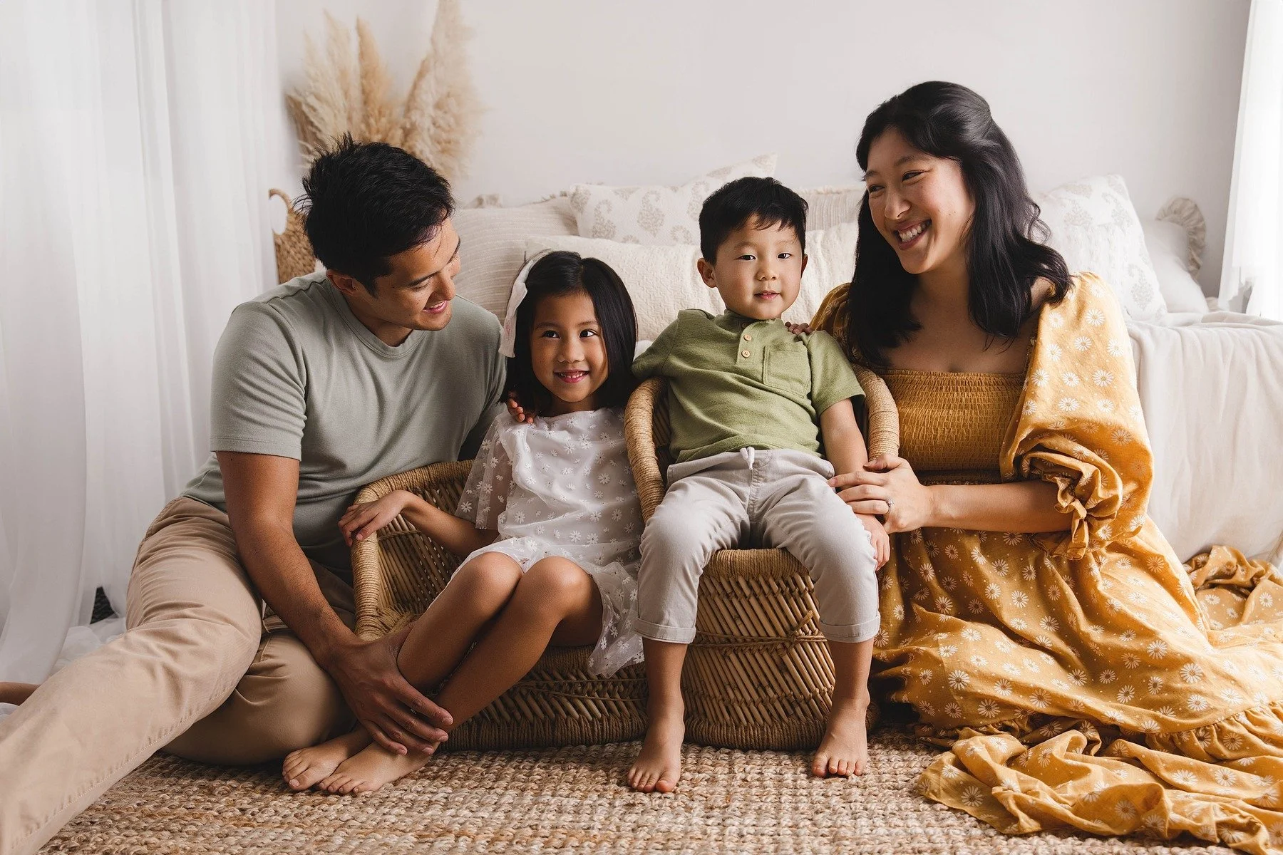 Lifestyle maternity photography in Allen, Texas: family portrait in a soft neutral studio, photographed by Manal Ansari