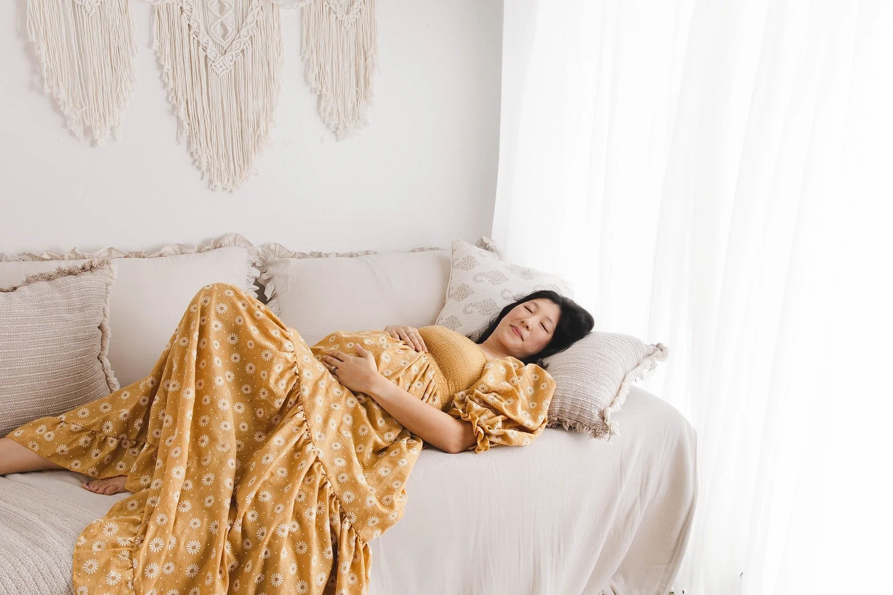 Lifestyle maternity photography in Allen, Texas: solo maternity portrait in a soft neutral studio, photographed by Manal Ansari