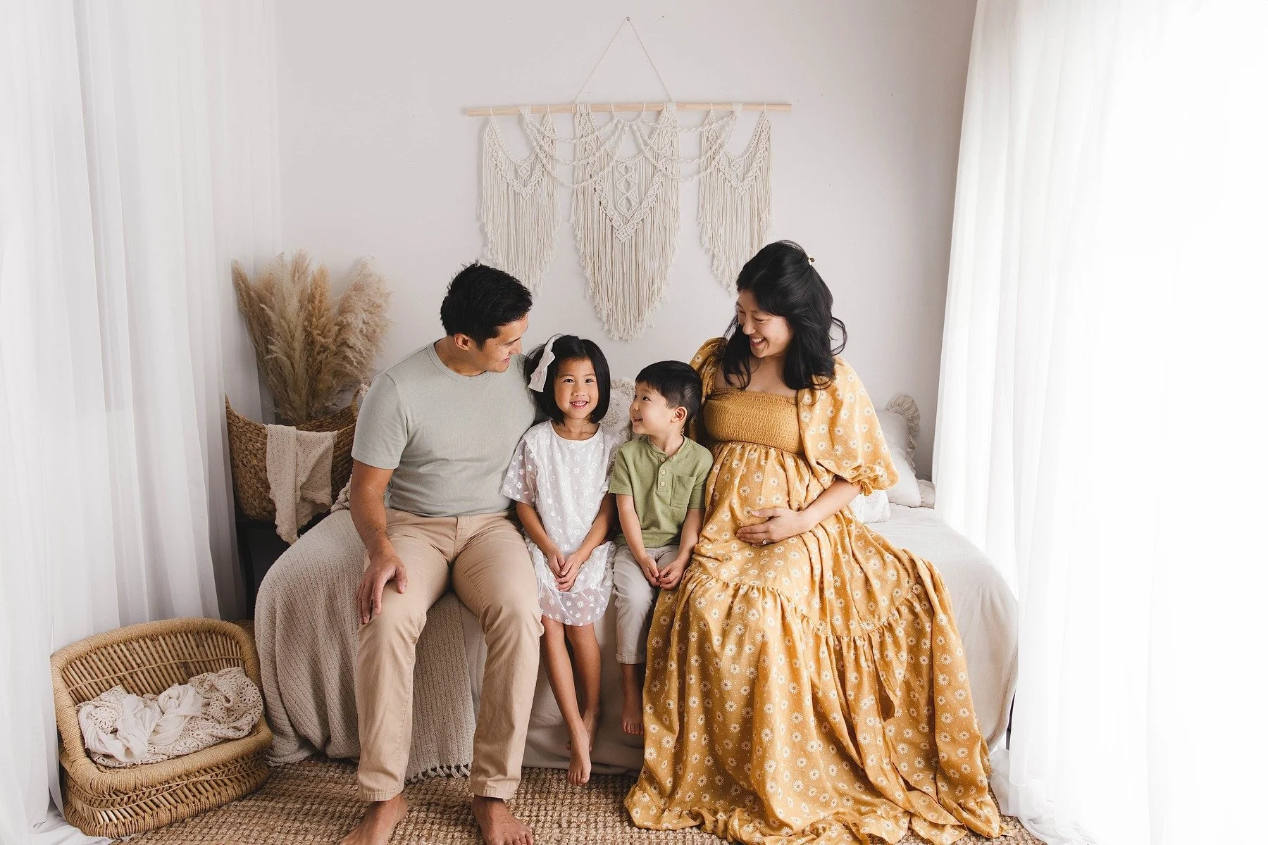 Lifestyle maternity photography in Allen, Texas: family portrait in a soft neutral studio, photographed by Manal Ansari