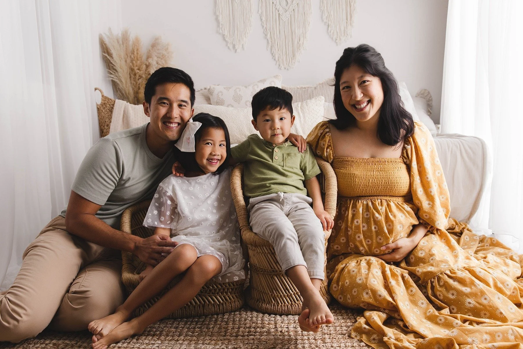Lifestyle maternity photography in Allen, Texas: family portrait in a soft neutral studio, photographed by Manal Ansari