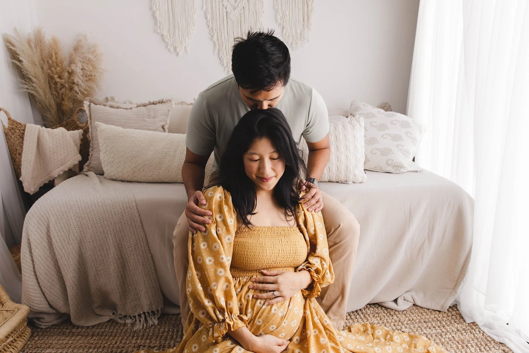 Lifestyle maternity photography in Allen, Texas: couple portrait in a soft neutral studio, photographed by Manal Ansari