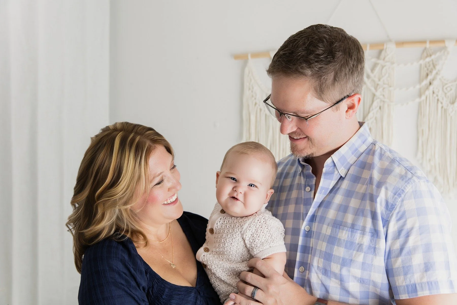 Six-month-old Baby Paxton with his parents during a Family Story milestone session