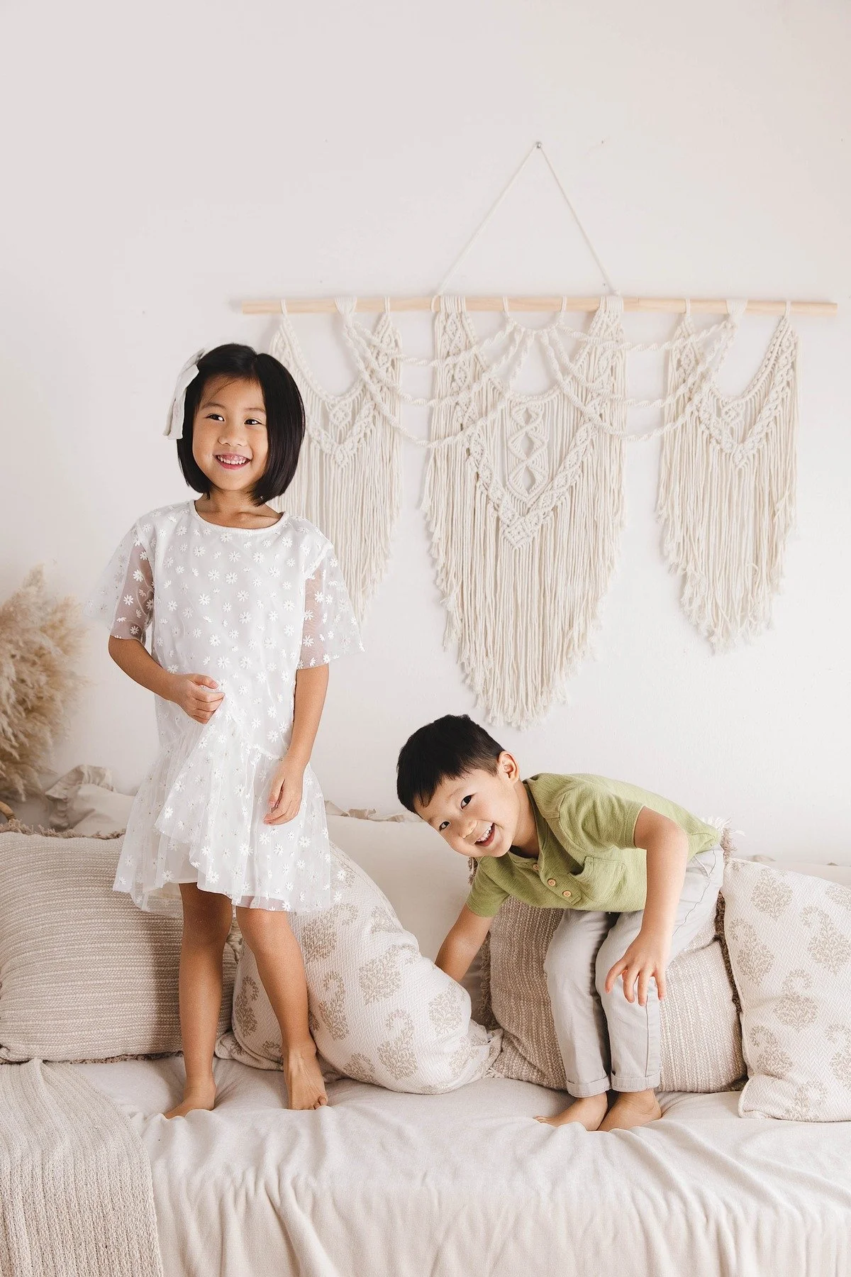 Lifestyle maternity photography in Allen, Texas: sibling portrait in a soft neutral studio, photographed by Manal Ansari