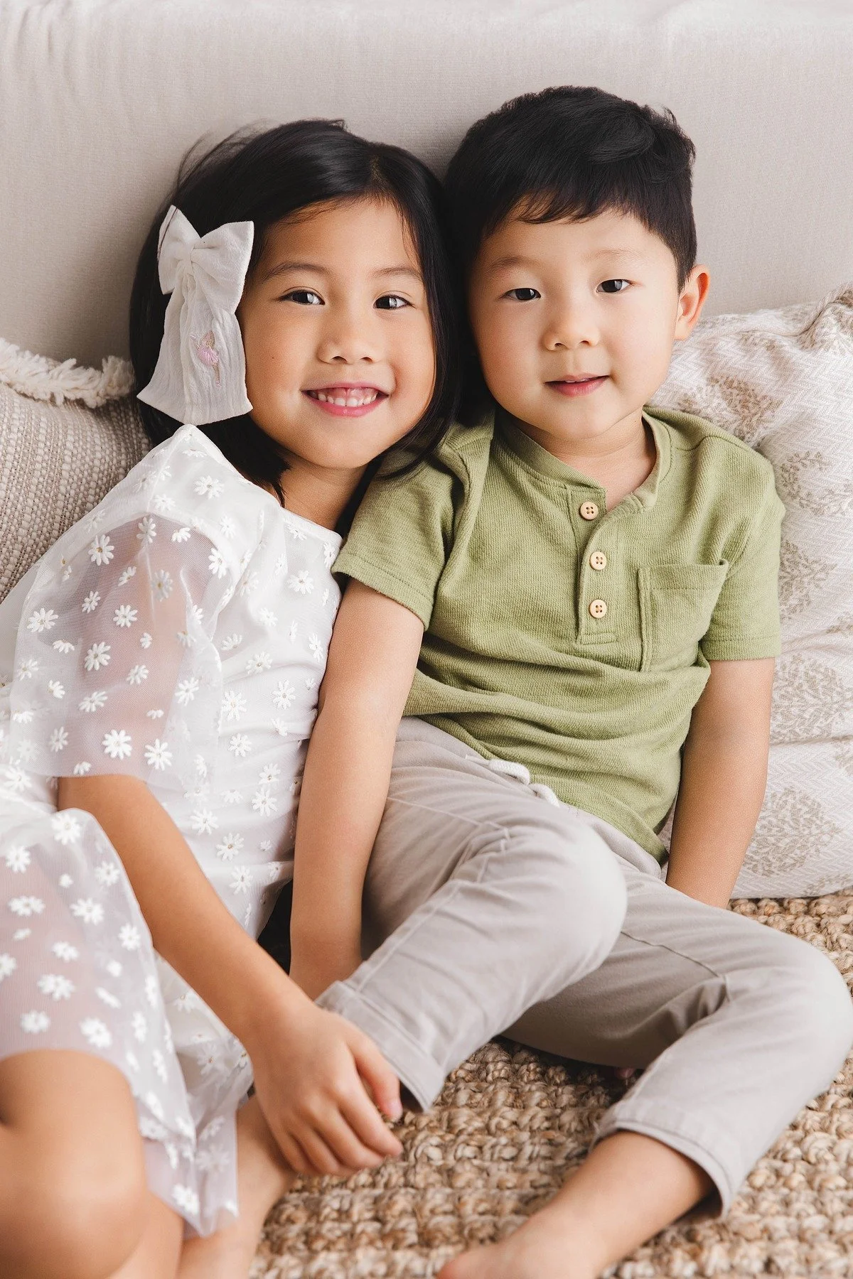 Lifestyle maternity photography in Allen, Texas: sibling portrait in a soft neutral studio, photographed by Manal Ansari