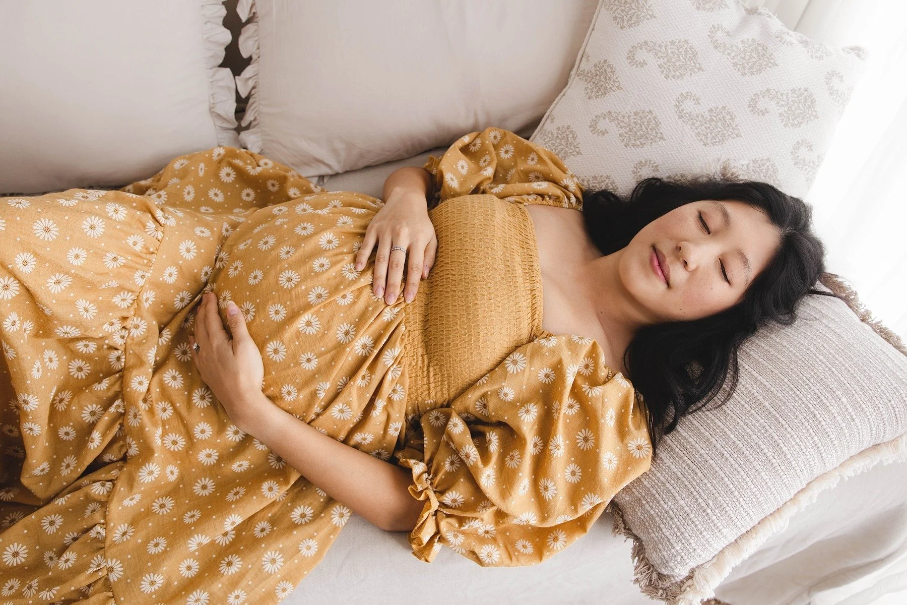 Lifestyle maternity photography in Allen, Texas: solo maternity portrait in a soft neutral studio, photographed by Manal Ansari