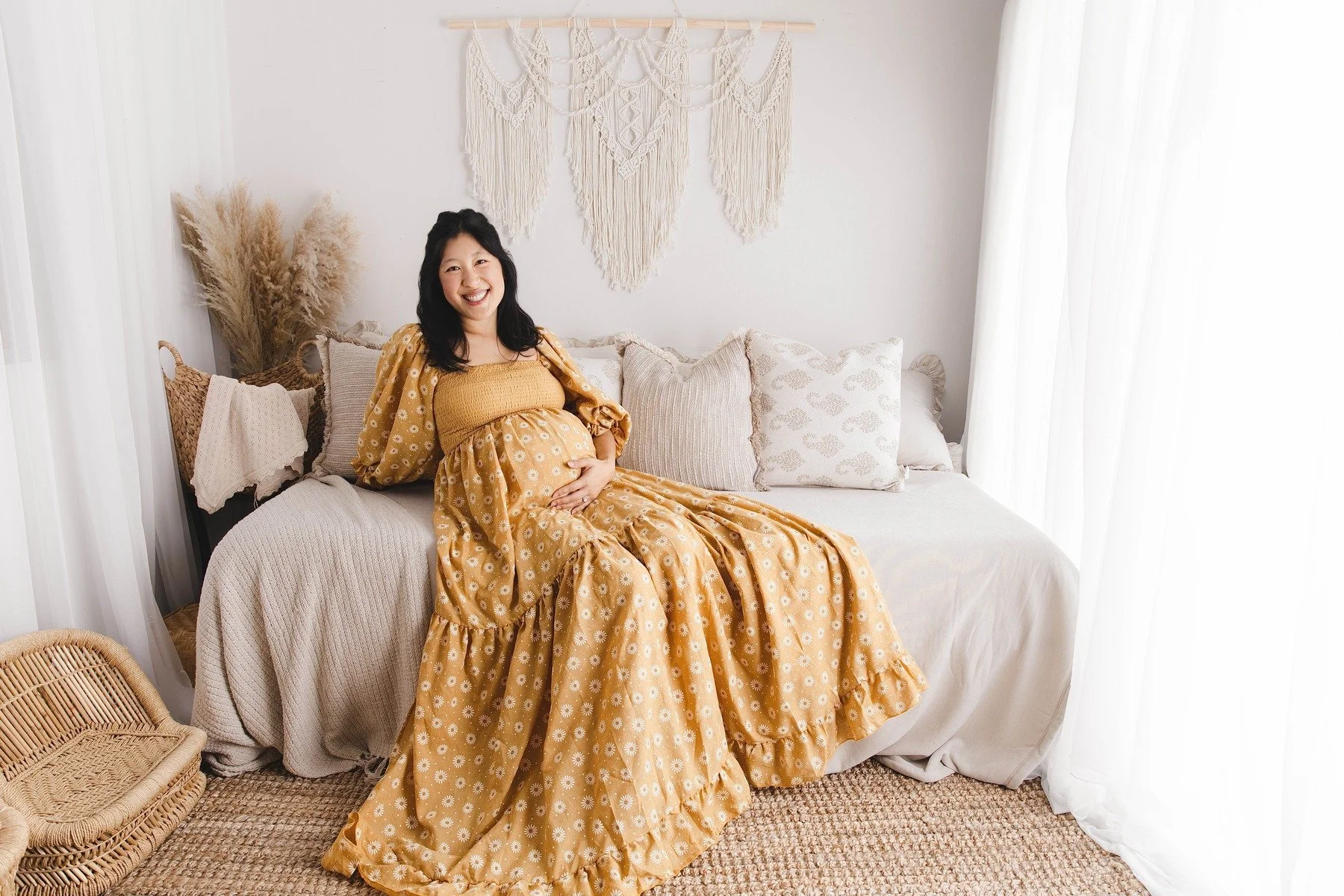Lifestyle maternity photography in Allen, Texas: solo maternity portrait in a soft neutral studio, photographed by Manal Ansari