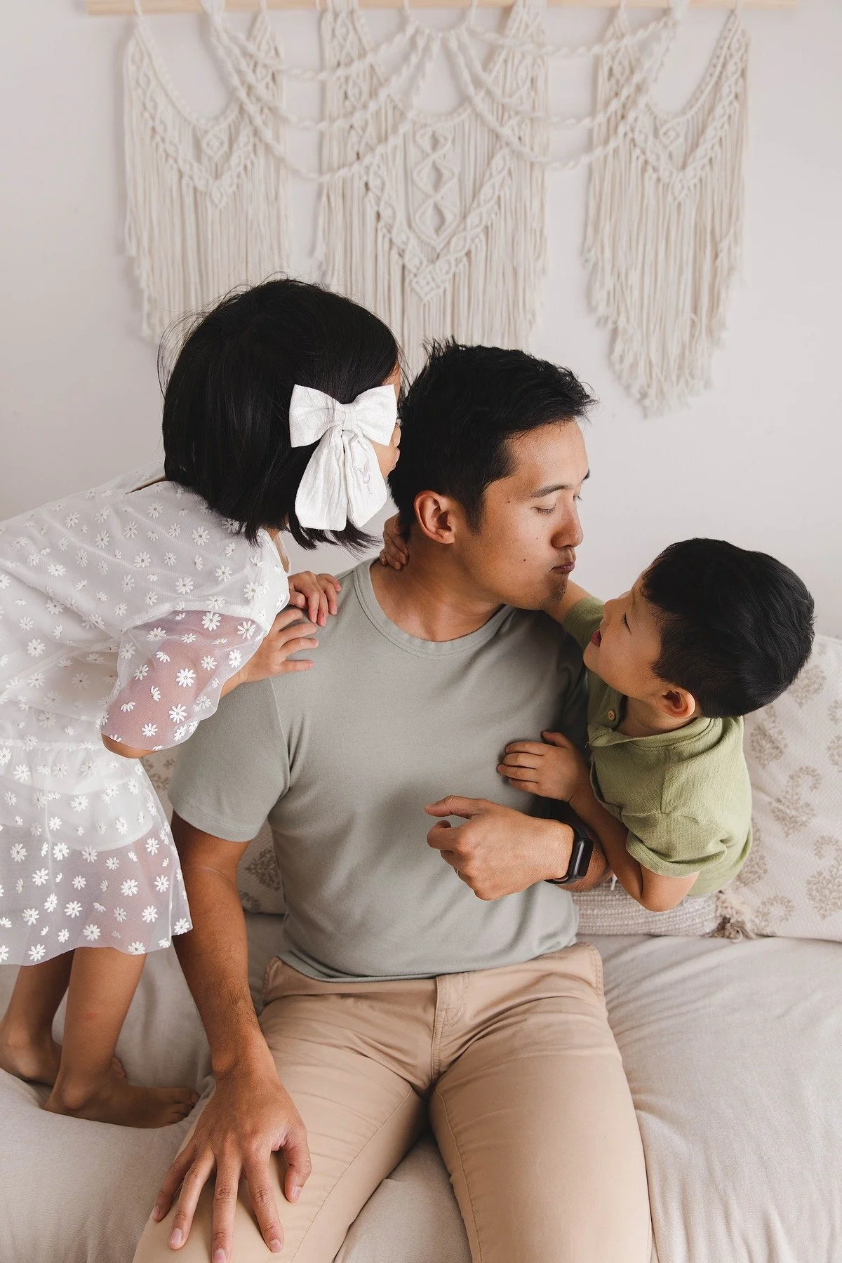Lifestyle maternity photography in Allen, Texas: dad and children in a soft neutral studio, photographed by Manal Ansari