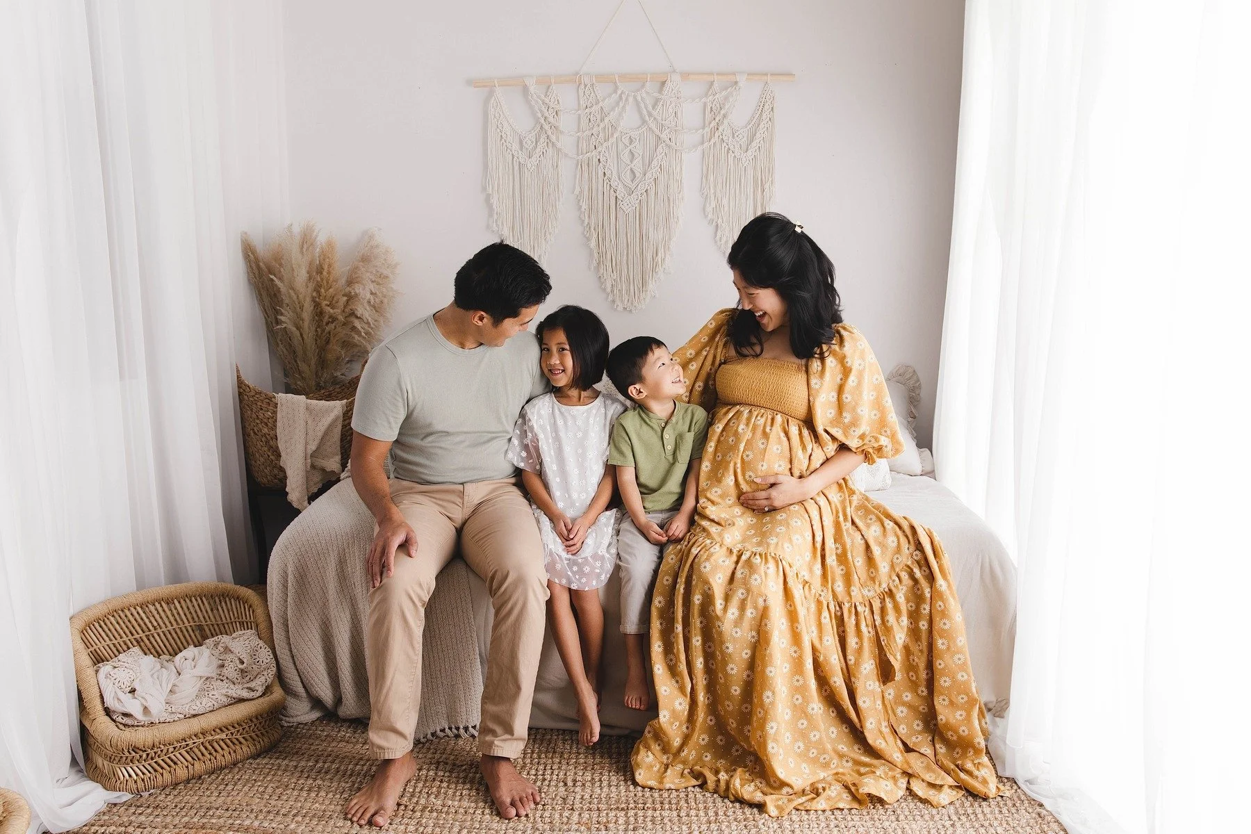 Lifestyle maternity photography in Allen, Texas: family portrait in a soft neutral studio, photographed by Manal Ansari