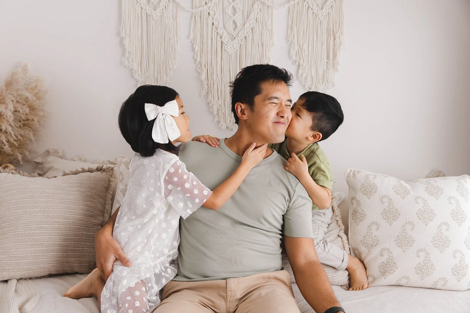 Lifestyle maternity photography in Allen, Texas: dad and children in a soft neutral studio, photographed by Manal Ansari