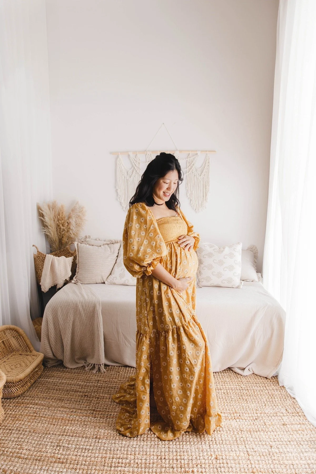 Solo maternity portrait of a mother in a yellow dress in the Allen lifestyle studio, photographed by Manal Ansari
