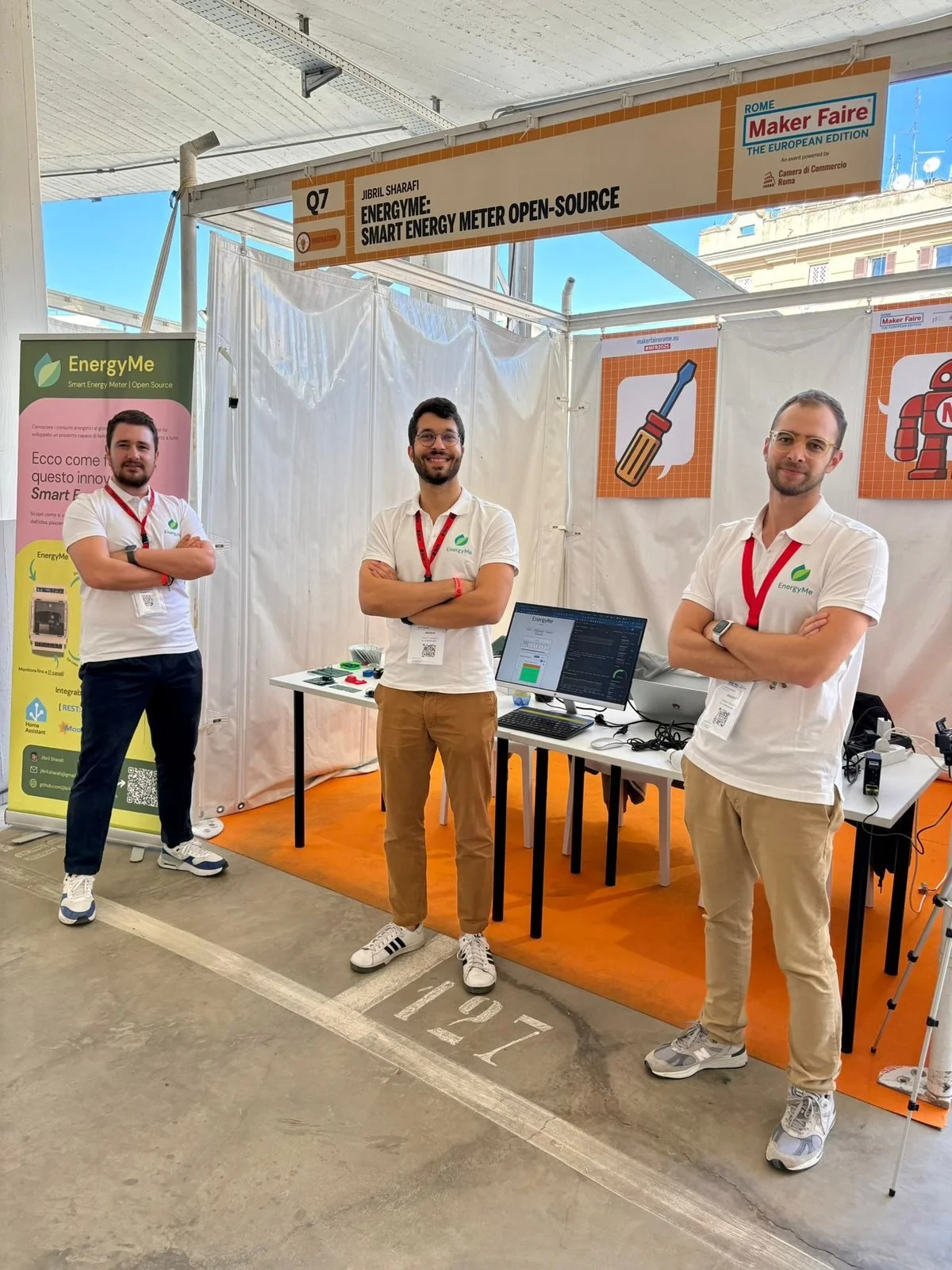 The three EnergyMe co-founders standing at their stand at Maker Faire Rome 2025