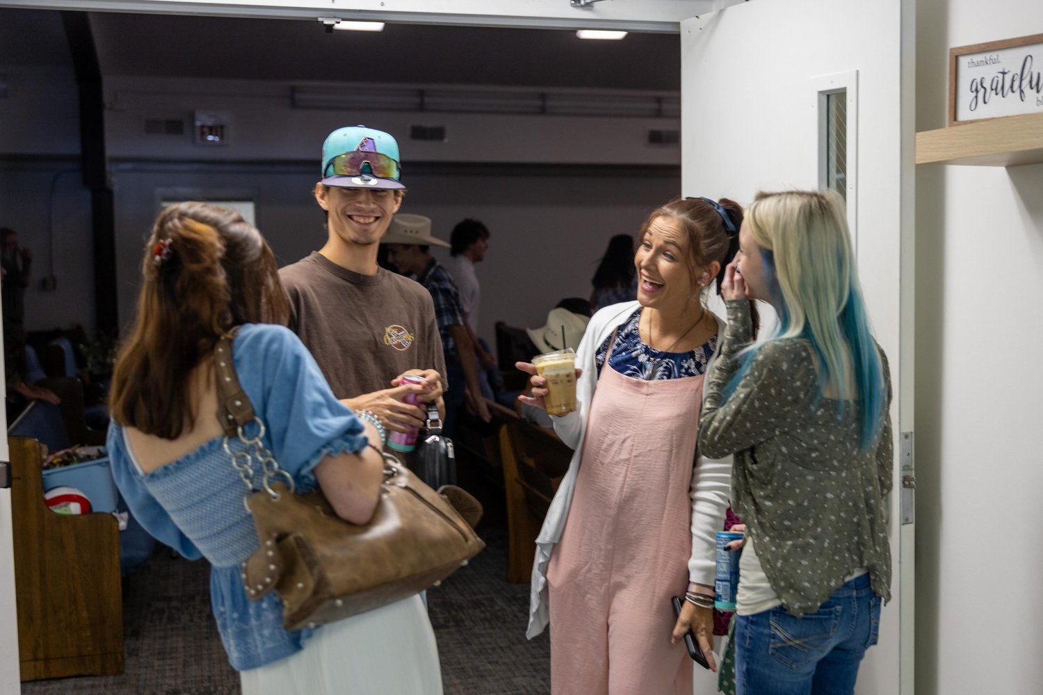 Friends talking in the lobby before service