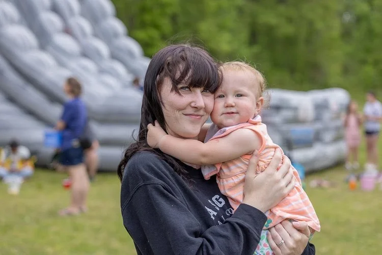 A mom hugging her little one at Easter