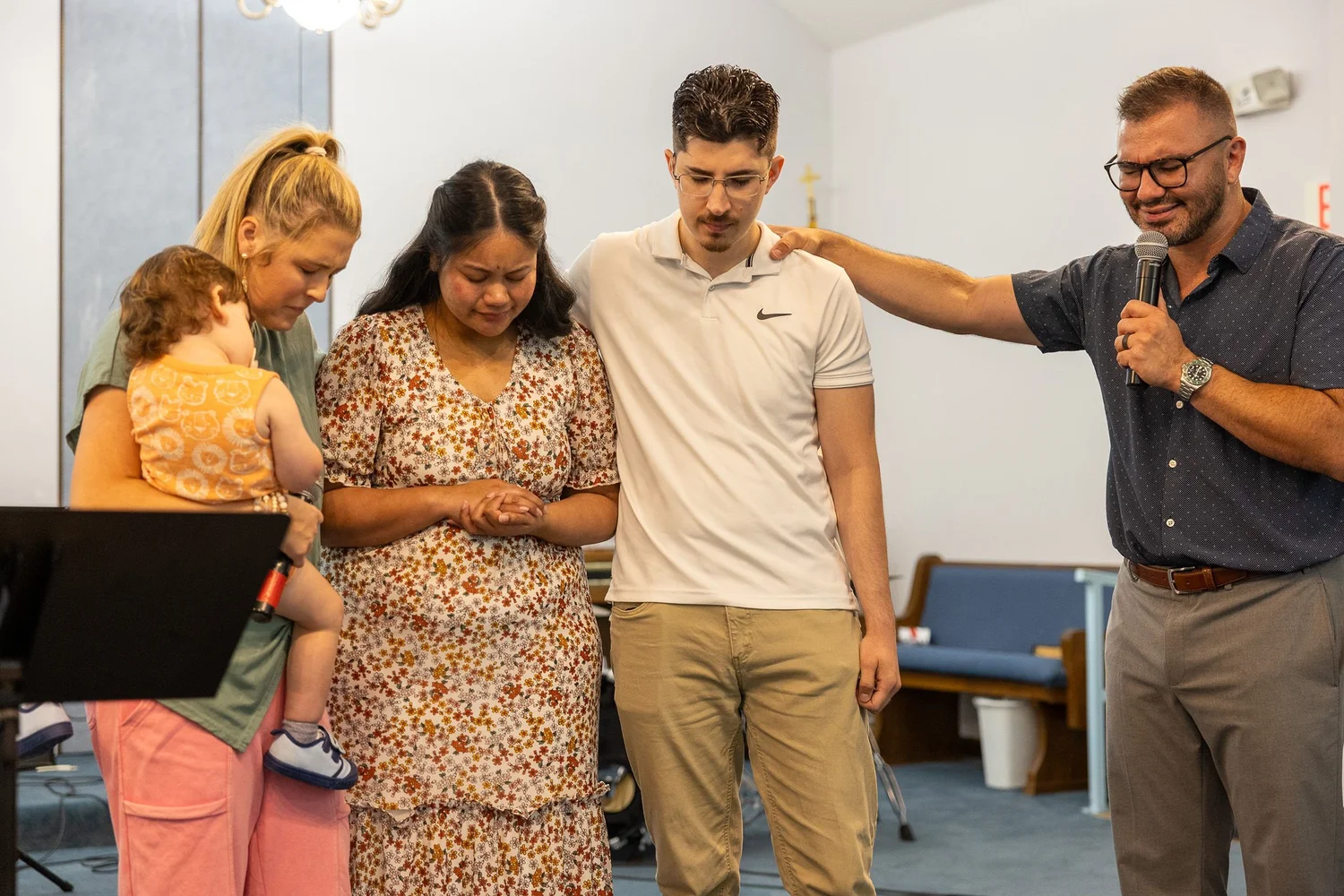 Pastor Simon praying with people at the altar
