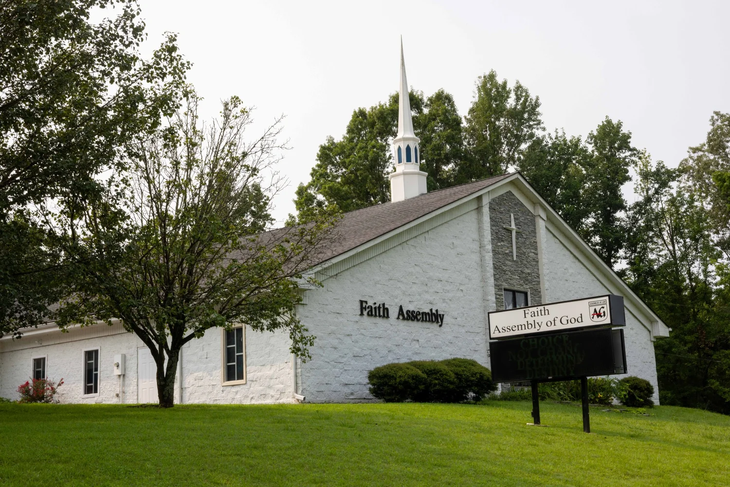 Faith Assembly of God building with steeple and sign