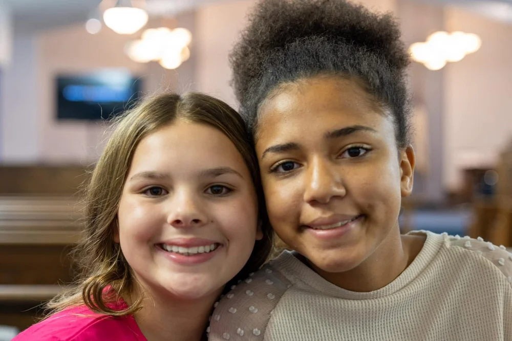 Two girls smiling together