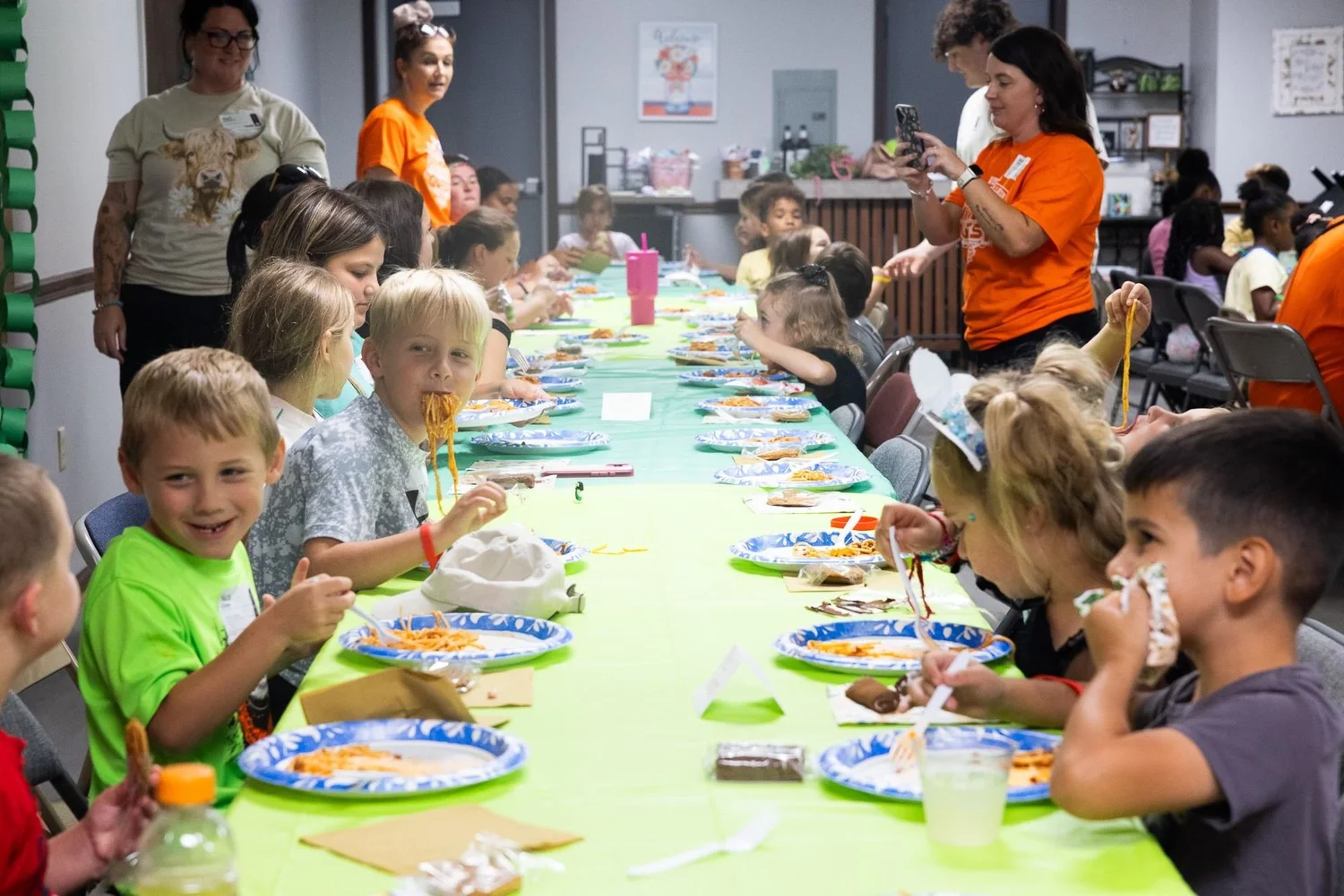 Kids eating at a long table
