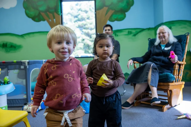 Toddlers smiling in the Faith Kids room