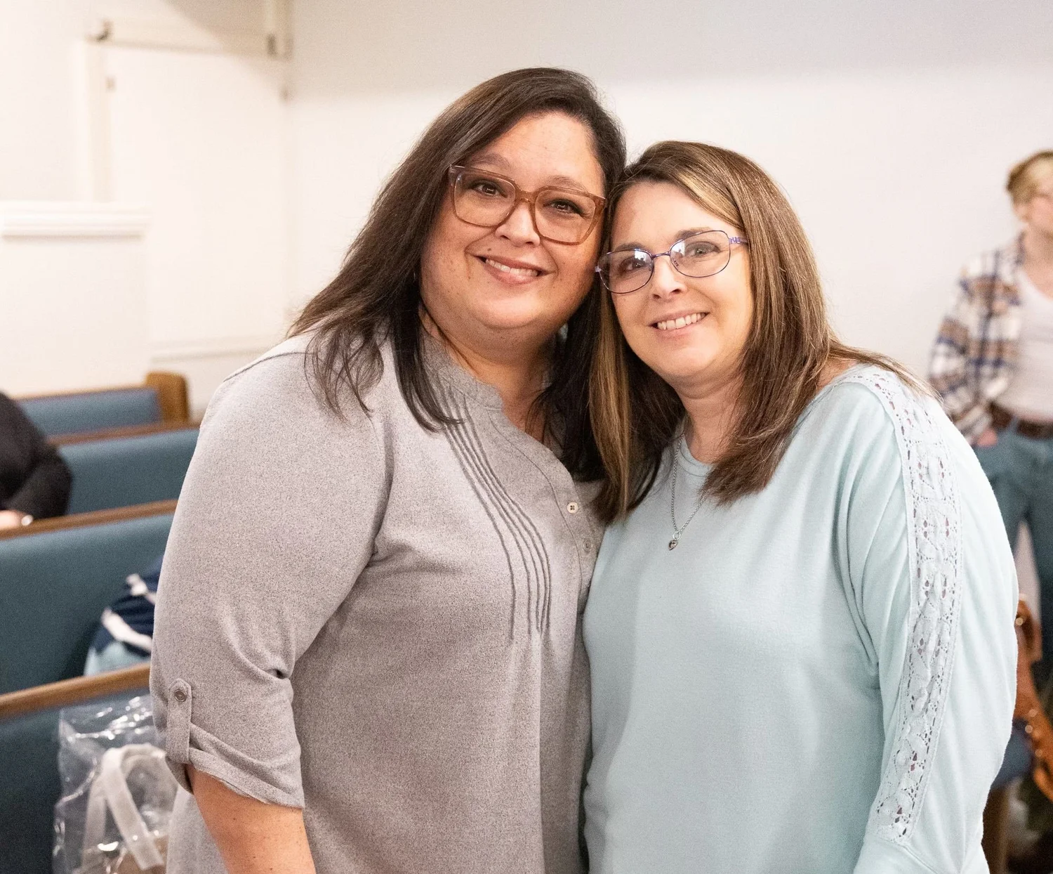 Two women hugging in the sanctuary