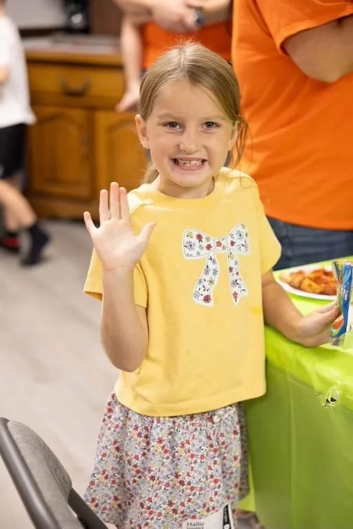 A girl waving