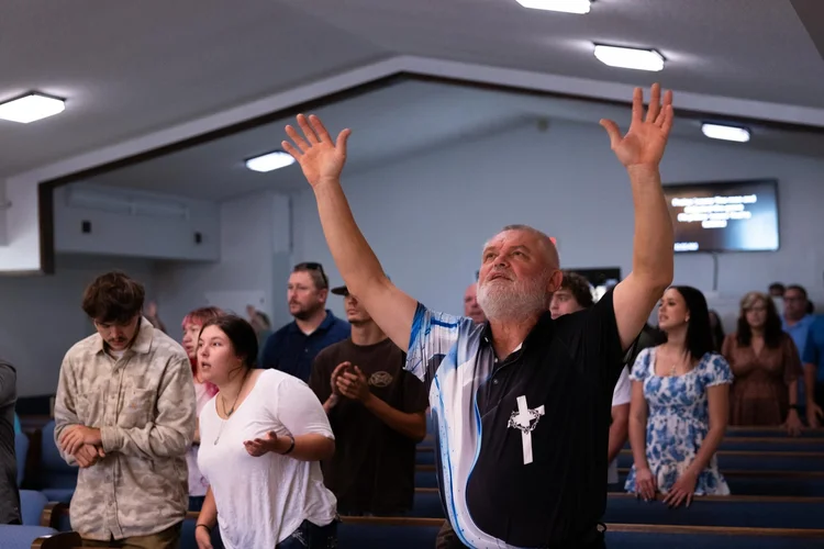 A man worshiping with both arms raised