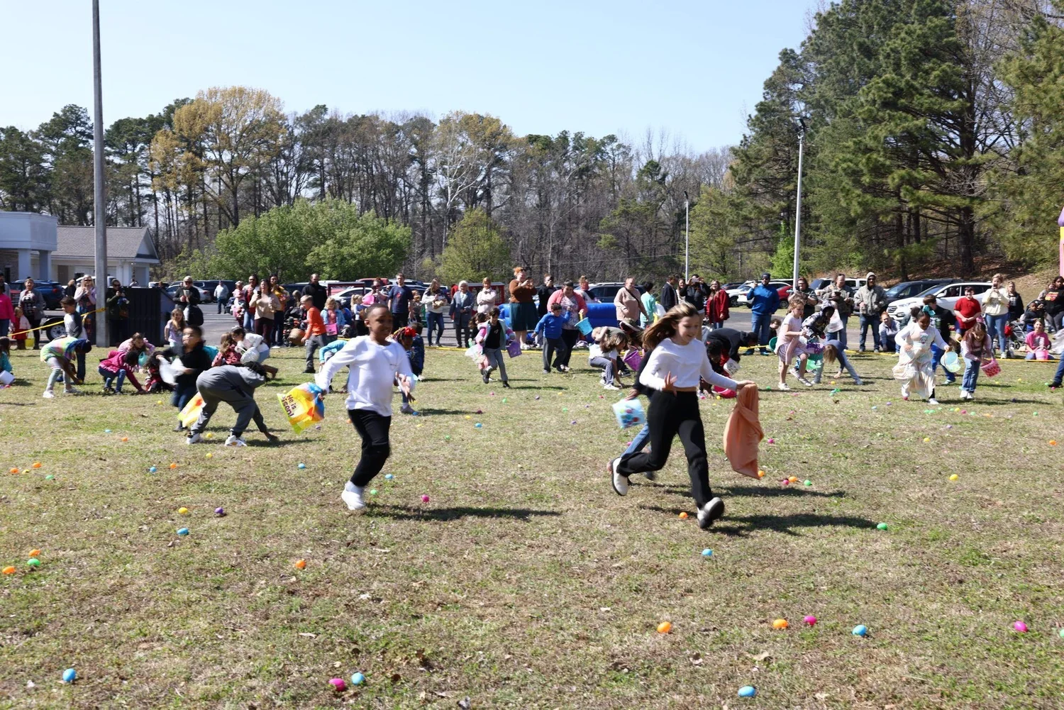Kids hunting eggs across the field