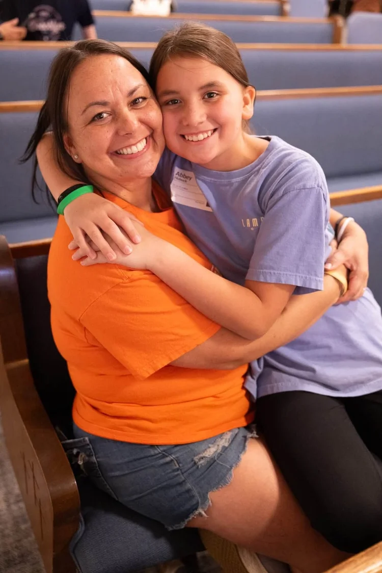 A leader and a girl hugging