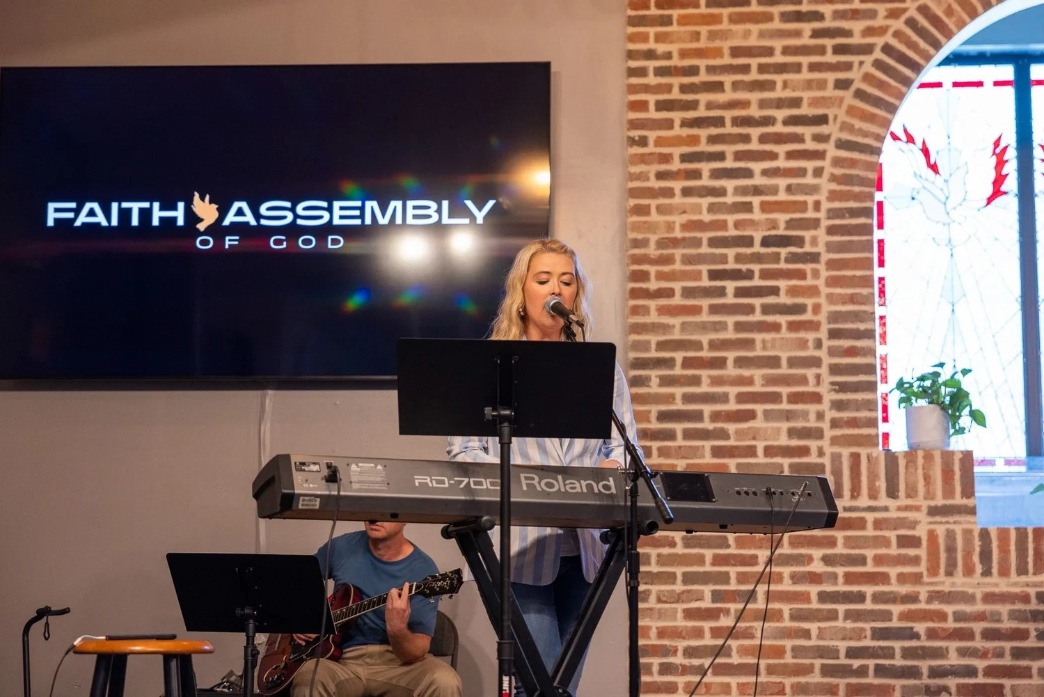Worship leader singing on stage