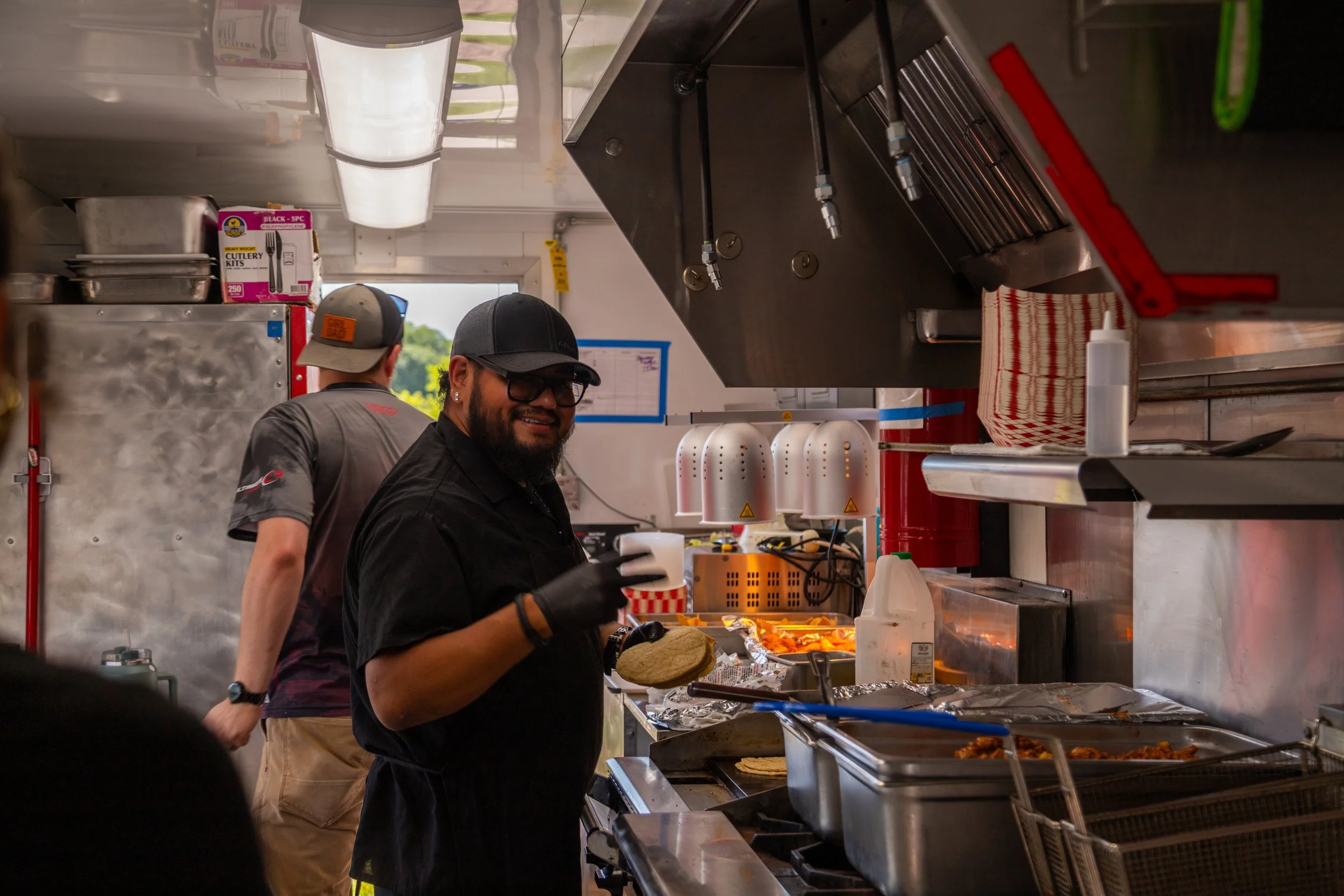 A Lavender Haze Mobile team member preparing food inside the mobile kitchen