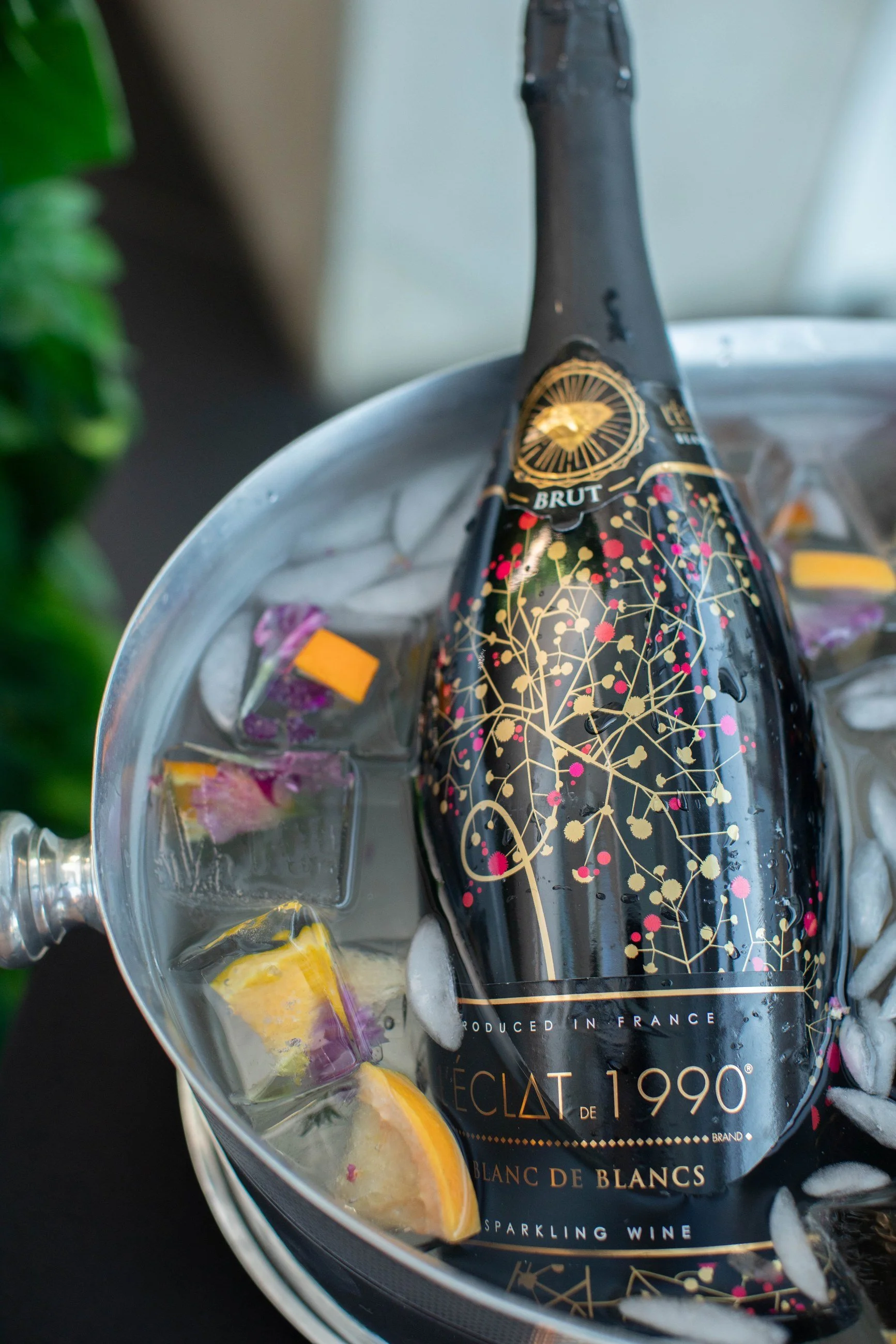 A hand-painted champagne bottle on ice from Alfred Mixology
