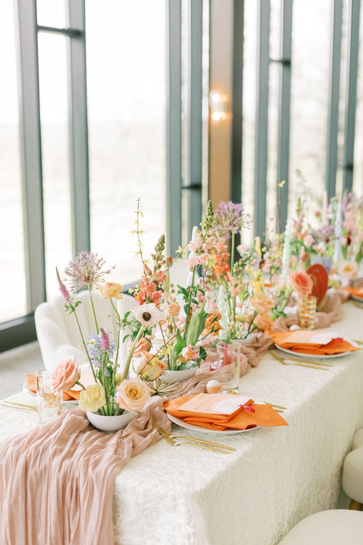 Colorful flowers and place settings, supplied by Light as a Feather Events