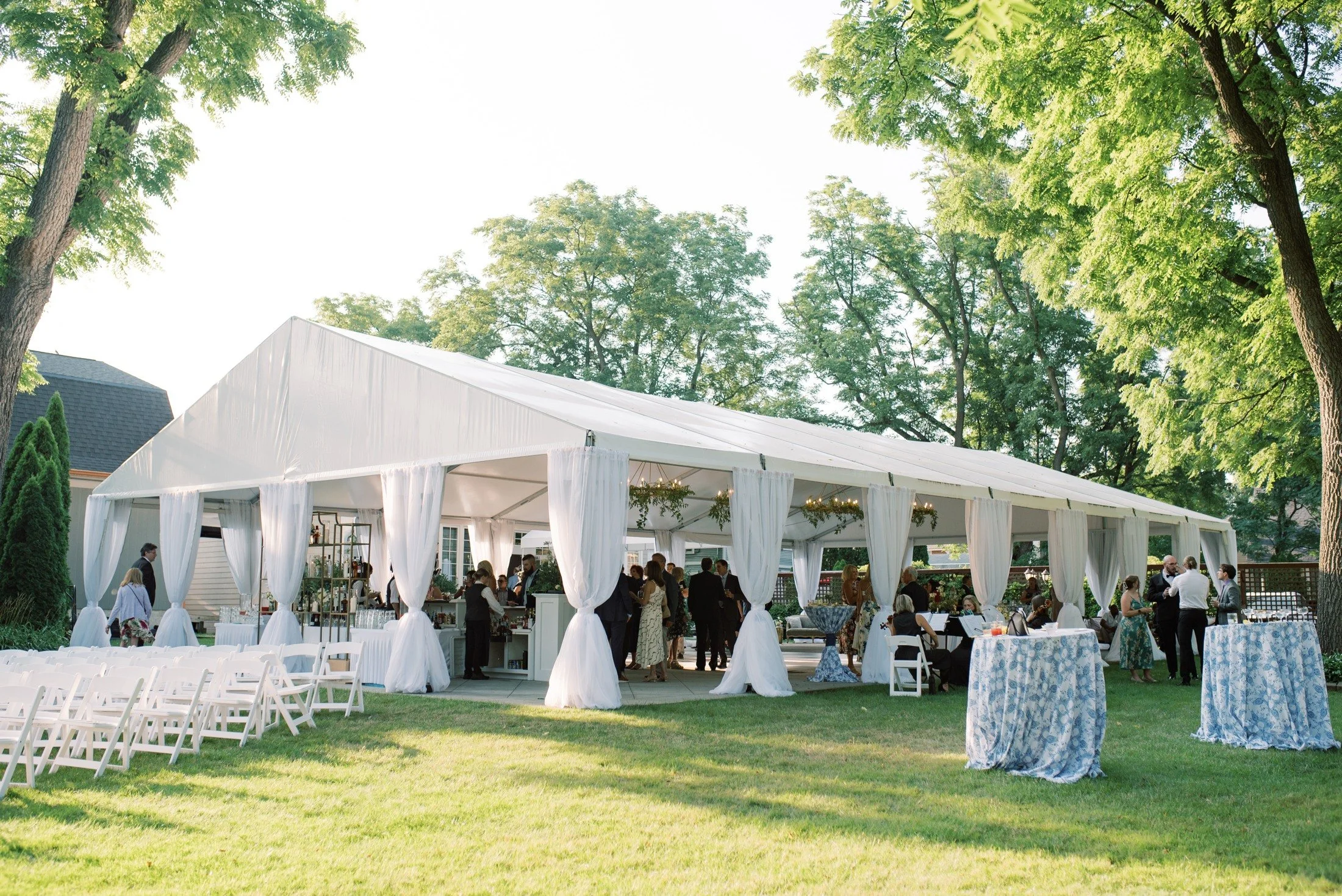 A white wedding tent on a tree-lined private estate, supplied by Blue Fancy Events