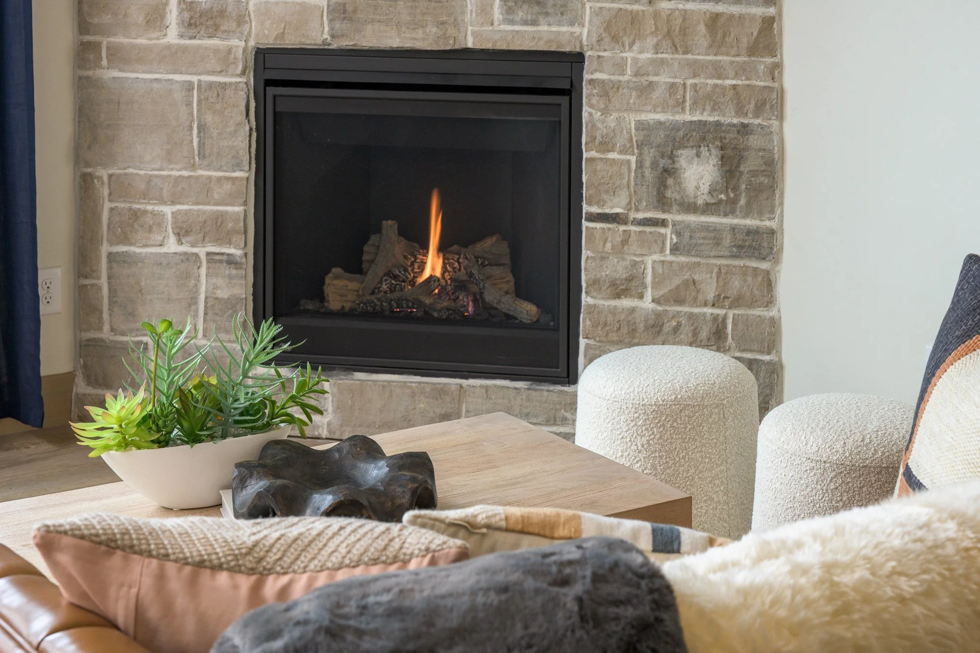 Davenport Fraser lounge with textured seating beside a stone fireplace