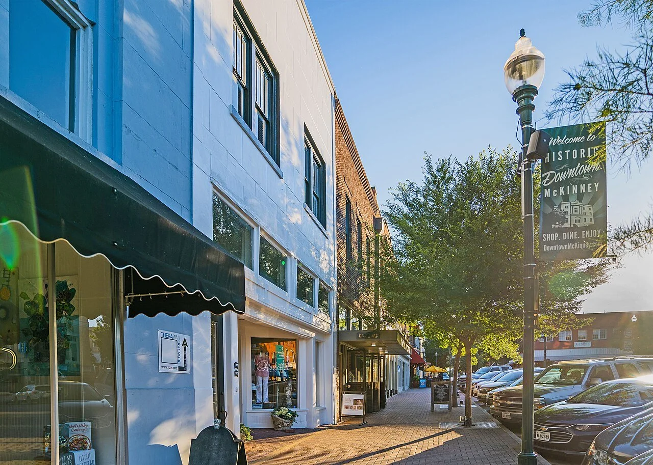 Downtown McKinney storefronts and the Historic Downtown banner in morning light